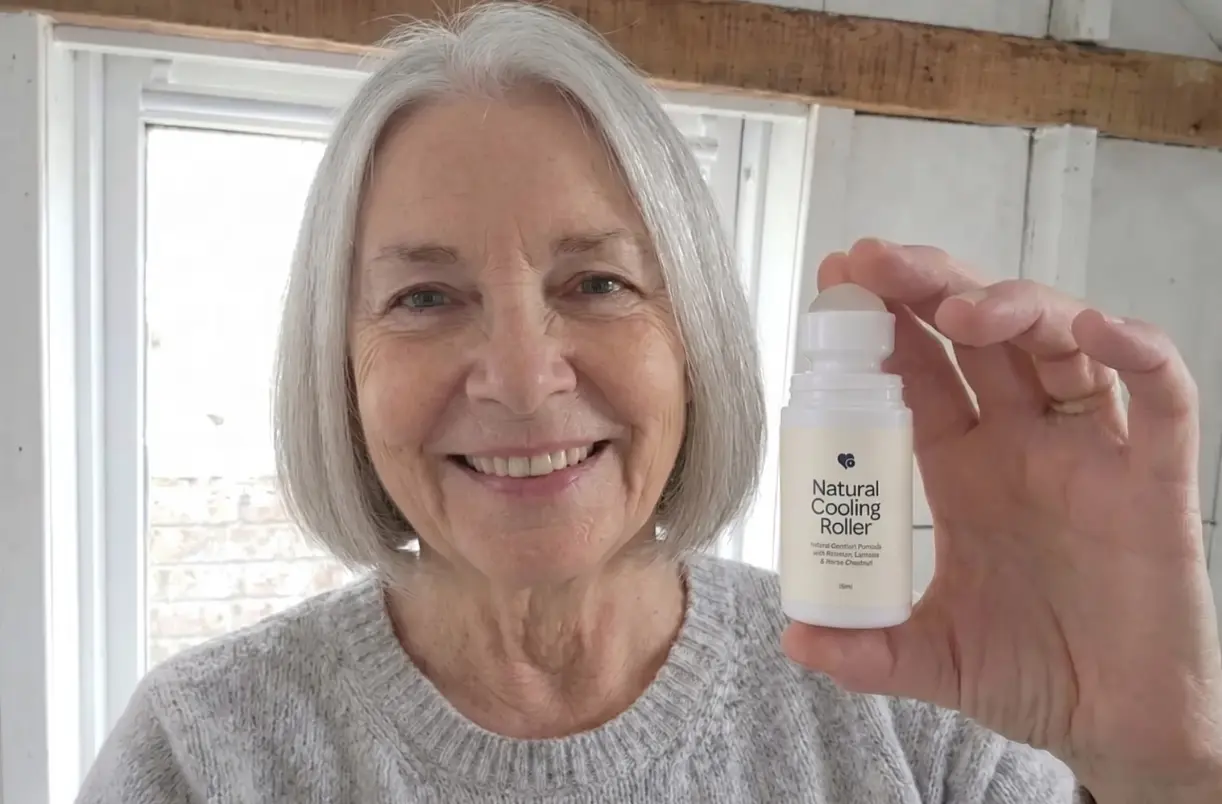 Smiling woman with grey hair holding up the Natural Cooling Roller